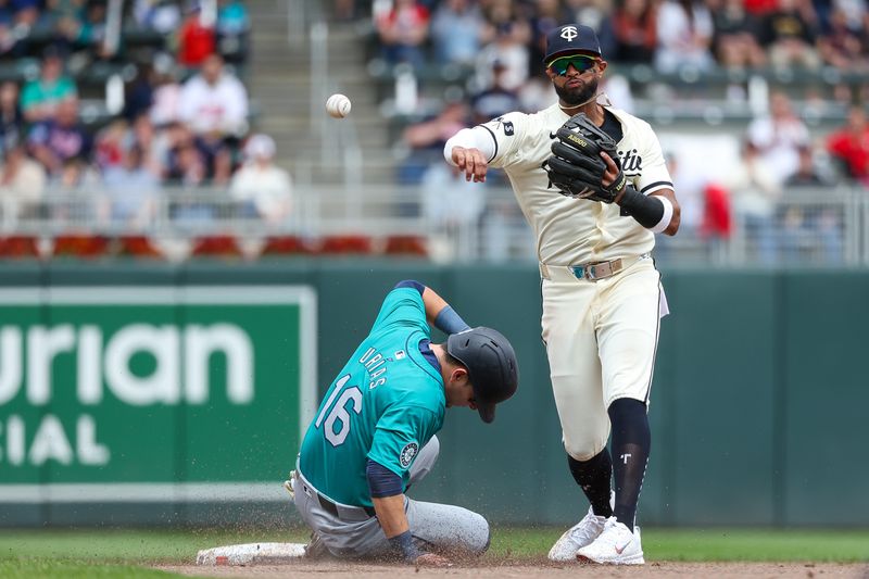 May 9, 2024; Minneapolis, Minnesota, USA; Seattle Mariners Luis Urías (16) is out at second base as Minnesota Twins shortstop Willi Castro (50) throws to first base on a fielders choice during the fifth inning at Target Field. Mandatory Credit: Matt Krohn-USA TODAY Sports