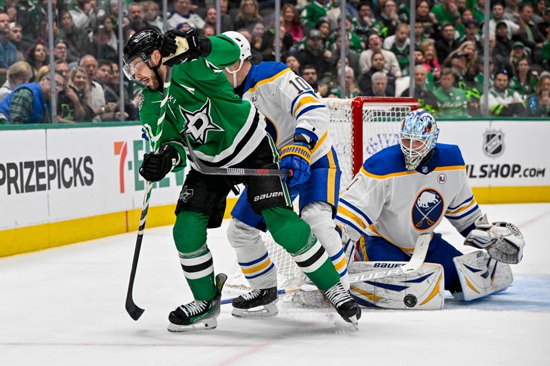 Apr 9, 2024; Dallas, Texas, USA; Dallas Stars center Tyler Seguin (91) makes a between the legs pass past Buffalo Sabres defenseman Henri Jokiharju (10) and goaltender Ukko-Pekka Luukkonen (1) during the second period at the American Airlines Center. Mandatory Credit: Jerome Miron-USA TODAY Sports