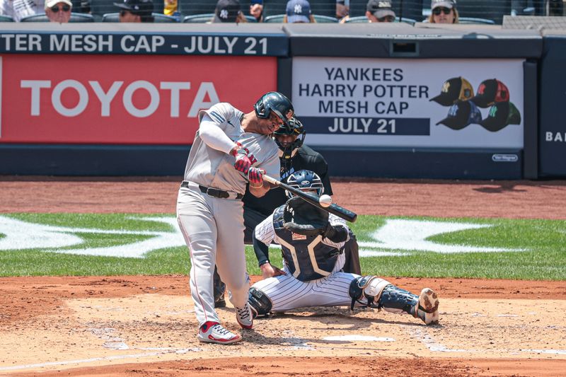 Jul 6, 2024; Bronx, New York, USA; Boston Red Sox third baseman Rafael Devers (11) hits an RBI single during the third inning against the New York Yankees at Yankee Stadium. Mandatory Credit: Vincent Carchietta-USA TODAY Sports