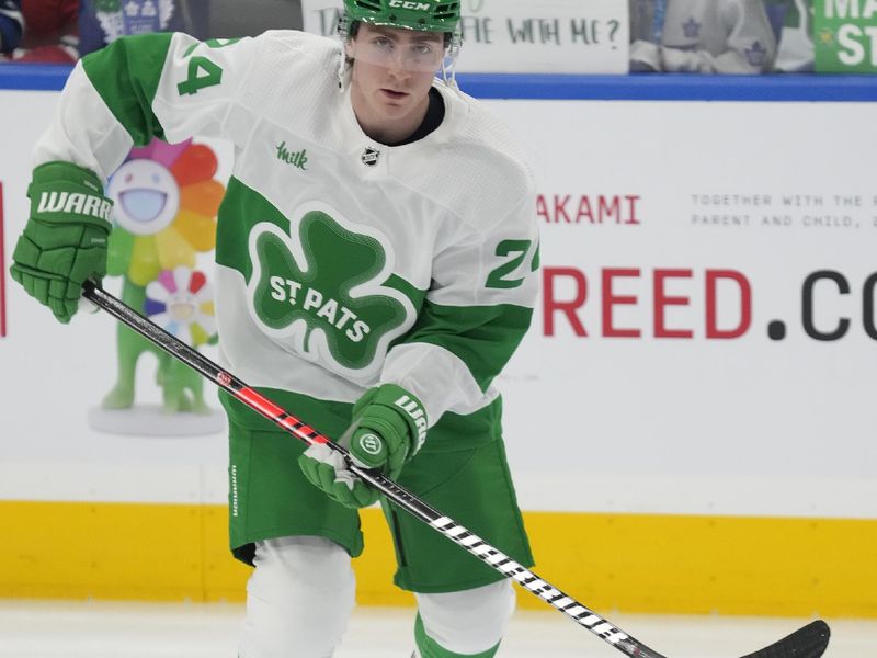 Mar 16, 2024; Toronto, Ontario, CAN; Toronto Maple Leafs forward Connor Dewar (24) skates with the puck during warm up before a game against the Carolina Hurricanes at Scotiabank Arena. Mandatory Credit: John E. Sokolowski-USA TODAY Sports