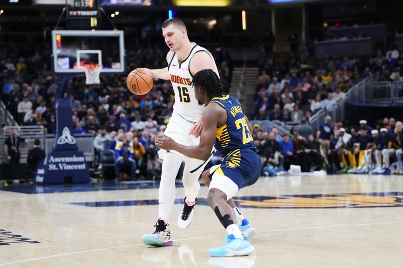 INDIANAPOLIS, INDIANA - JANUARY 23: Nikola Jokic #15 of the Denver Nuggets dribbles the ball while being guarded by Aaron Nesmith #23 of the Indiana Pacers in the second quarter at Gainbridge Fieldhouse on January 23, 2024 in Indianapolis, Indiana. NOTE TO USER: User expressly acknowledges and agrees that, by downloading and or using this photograph, User is consenting to the terms and conditions of the Getty Images License Agreement. (Photo by Dylan Buell/Getty Images)