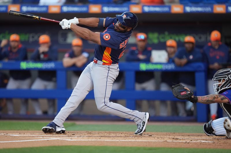 Mar 6, 2025; Port St. Lucie, Florida, USA;  Houston Astros first baseman Jon Singleton (28) hits a single to score a run in the first inning against the New York Mets at Clover Park. Mandatory Credit: Jim Rassol-Imagn Images