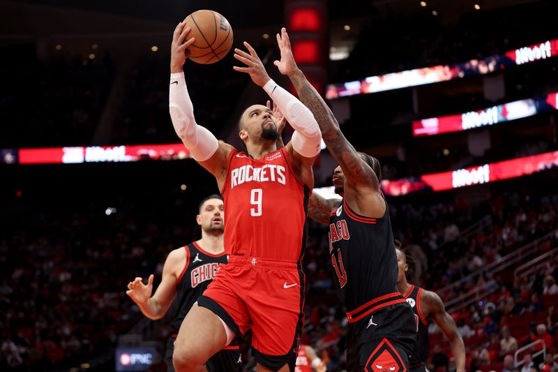 HOUSTON, TEXAS - MARCH 21: Dillon Brooks #9 of the Houston Rockets goes up for a shot against DeMar DeRozan #11 of the Chicago Bulls in the first half at Toyota Center on March 21, 2024 in Houston, Texas.  NOTE TO USER: User expressly acknowledges and agrees that, by downloading and or using this photograph, User is consenting to the terms and conditions of the Getty Images License Agreement. (Photo by Tim Warner/Getty Images)