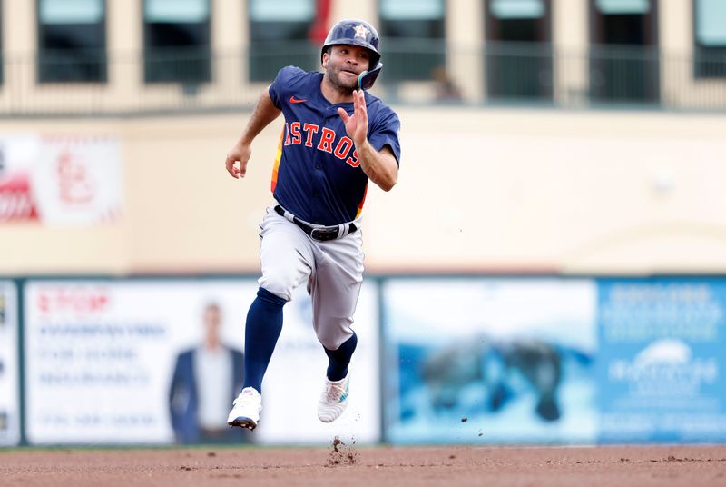 Mar 7, 2024; Jupiter, Florida, USA; Houston Astros second baseman Jose Altuve (27) heads for third base against the St. Louis Cardinals in the first inning at Roger Dean Chevrolet Stadium. Mandatory Credit: Rhona Wise-USA TODAY Sports