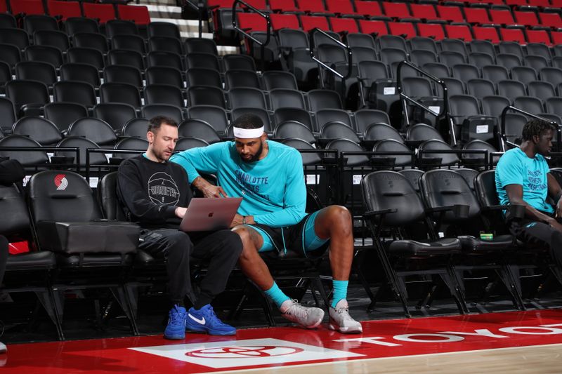 PORTLAND, OR - FEBRUARY 25: Assistant Coach Nick Friedman of the Charlotte Hornets   & Marques Bolden #12 of the Charlotte Hornets  look at film before the game   on February 25, 2024 at the Moda Center Arena in Portland, Oregon. NOTE TO USER: User expressly acknowledges and agrees that, by downloading and or using this photograph, user is consenting to the terms and conditions of the Getty Images License Agreement. Mandatory Copyright Notice: Copyright 2024 NBAE (Photo by Cameron Browne/NBAE via Getty Images)