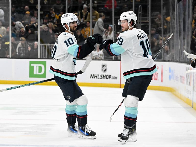 Feb 15, 2024; Boston, Massachusetts, USA; Seattle Kraken left wing Jared McCann (19) celebrates with center Matty Beniers (10) after scoring a goal against the Boston Bruins during the third period at the TD Garden. Mandatory Credit: Brian Fluharty-USA TODAY Sports