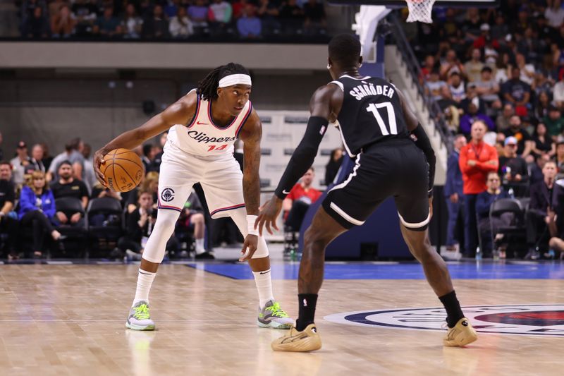 OCEANSIDE, CALIFORNIA - OCTOBER 08: Terance Mann #14 of the Los Angeles Clippers tries to move past Dennis Schroder #17 of the Brooklyn Nets in the second quarter of the preseason game at Frontwave Arena on October 08, 2024 in Oceanside, California. NOTE TO USER: User expressly acknowledges and agrees that, by downloading and or using this photograph, User is consenting to the terms and conditions of the Getty Images License Agreement. (Photo by Joe Scarnici/Getty Images)