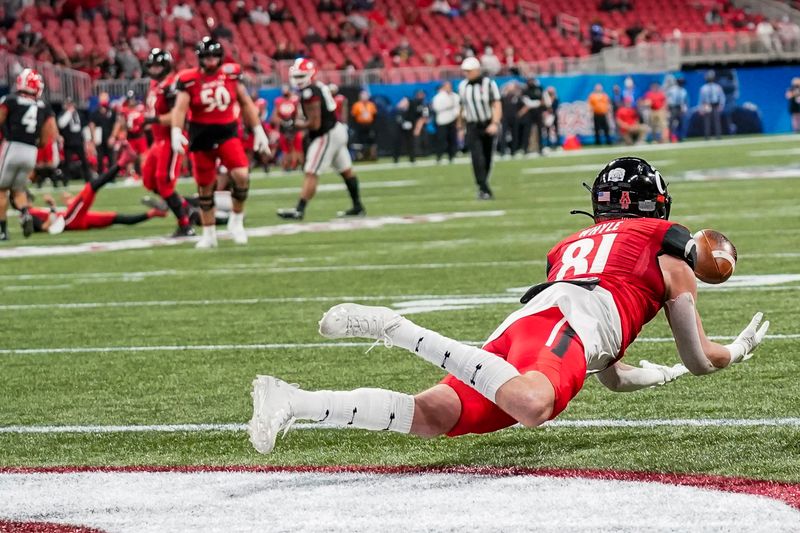 Jan 1, 2021; Atlanta, GA, USA; Cincinnati Bearcats tight end Josh Whyle (81) catches a touchdown pass against the Georgia Bulldogs during the first half at Mercedes-Benz Stadium. Mandatory Credit: Dale Zanine-USA TODAY Sports