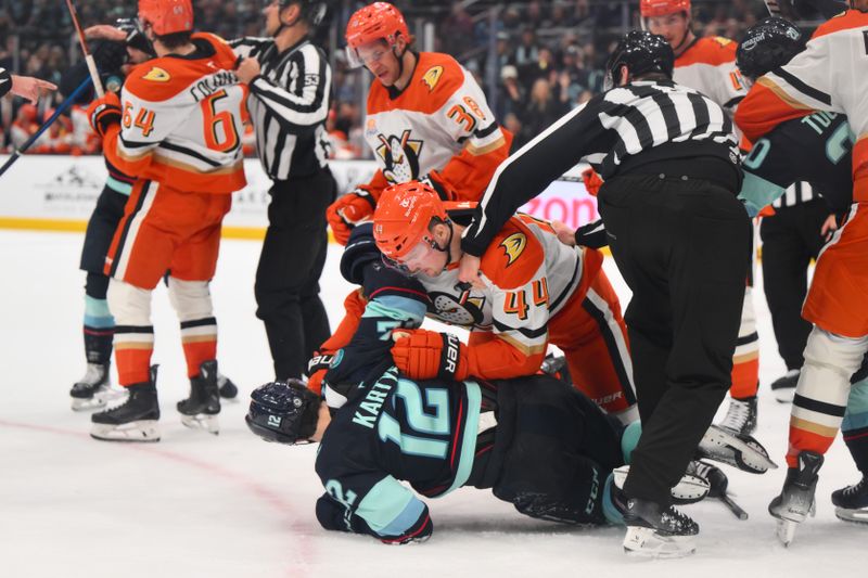 Nov 27, 2024; Seattle, Washington, USA; Anaheim Ducks left wing Ross Johnston (44) punches Seattle Kraken left wing Tye Kartye (12) during the third period at Climate Pledge Arena. Mandatory Credit: Steven Bisig-Imagn Images