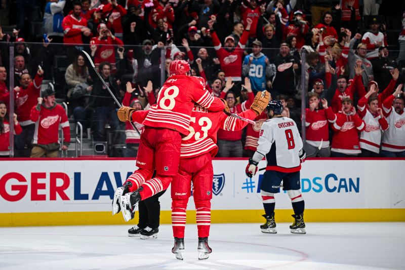 Dec 21, 2025; Detroit, Michigan, USA; Detroit Red Wings defenseman Moritz Seider (53) celebrates his game winning goal with center Andrew Copp (18) during overtime against the Washington Capitals at Little Caesars Arena. Mandatory Credit: Tim Fuller-Imagn Images