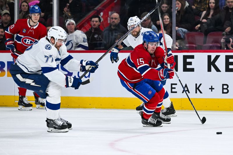 Apr 4, 2024; Montreal, Quebec, CAN; Montreal Canadiens center Alex Newhook (15)plays the puck against Tampa Bay Lightning defenseman Victor Hedman (77) during the first period at Bell Centre. Mandatory Credit: David Kirouac-USA TODAY Sports