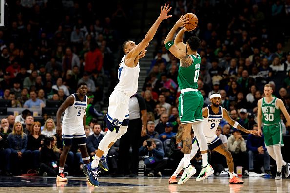 MINNEAPOLIS, MINNESOTA - NOVEMBER 06: Jayson Tatum #0 of the Boston Celtics shoots the ball while Rudy Gobert #27 of the Minnesota Timberwolves defends in the first quarter at Target Center on November 06, 2023 in Minneapolis, Minnesota. NOTE TO USER: User expressly acknowledges and agrees that, by downloading and or using this photograph, User is consenting to the terms and conditions of the Getty Images License Agreement. (Photo by David Berding/Getty Images)