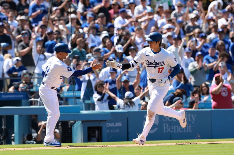 May 5, 2024; Los Angeles, California, USA;  Los Angeles Dodgers designated hitter Shohei Ohtani (17) is greeted by third base coach Dino Ebel (91) after hitting a home run during the eighth inning against the Atlanta Braves at Dodger Stadium. Mandatory Credit: Kiyoshi Mio-USA TODAY Sports