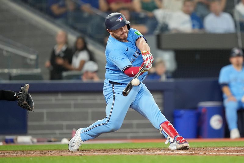 May 22, 2024; Toronto, Ontario, CAN; Toronto Blue Jays catcher Alejandro Kirk (30) makes contact with the ball during an at bat against the Chicago White Sox during the eighth inning at Rogers Centre. Mandatory Credit: John E. Sokolowski-USA TODAY Sports