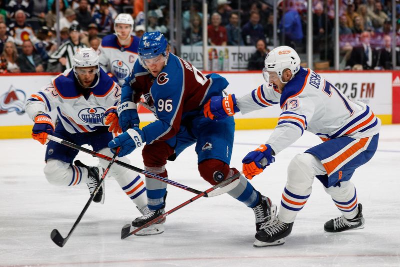 Apr 11, 2023; Denver, Colorado, USA; Colorado Avalanche right wing Mikko Rantanen (96) battles for the puck with Edmonton Oilers defenseman Darnell Nurse (25) an ddefenseman Vincent Desharnais (73) in the second period at Ball Arena. Mandatory Credit: Isaiah J. Downing-USA TODAY Sports