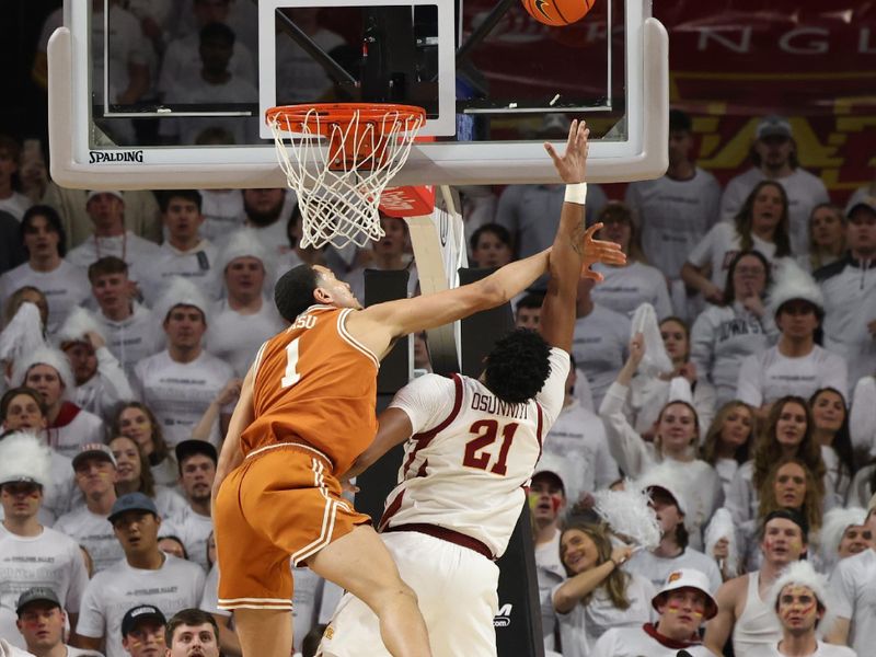 Jan 17, 2023; Ames, Iowa, USA; Iowa State Cyclones center Osun Osunniyi (21) is fouled by Texas Longhorns forward Dylan Disu (1) during the second half at James H. Hilton Coliseum. Mandatory Credit: Reese Strickland-USA TODAY Sports