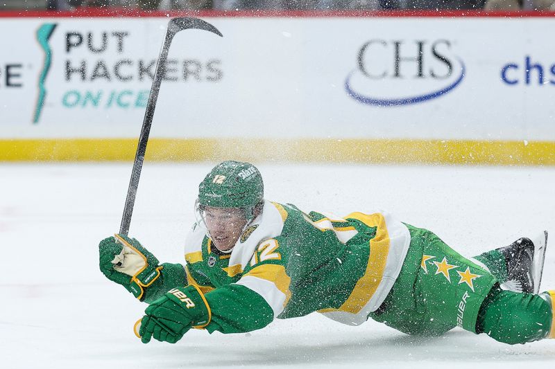 Jan 27, 2026; Saint Paul, Minnesota, USA; Minnesota Wild left wing Matt Boldy (12) falls during the second period against the Chicago Blackhawks at Grand Casino Arena. Mandatory Credit: Matt Krohn-Imagn Images