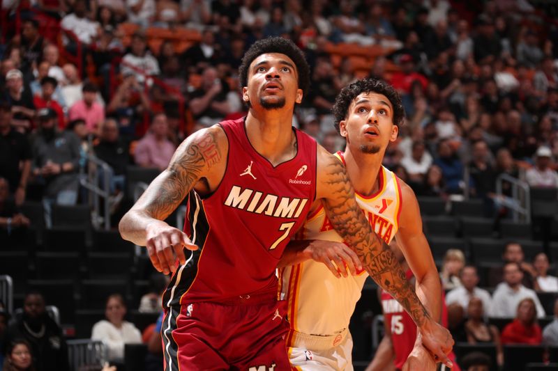 MIAMI, FL - FEBRUARY 26: Kel'el Ware #7 of the Miami Heat and Zaccharie Risacher #10 of the Atlanta Hawks boxes out during the game on February 26, 2025 at Kaseya Center in Miami, Florida. NOTE TO USER: User expressly acknowledges and agrees that, by downloading and or using this Photograph, user is consenting to the terms and conditions of the Getty Images License Agreement. Mandatory Copyright Notice: Copyright 2025 NBAE (Photo by Issac Baldizon/NBAE via Getty Images)