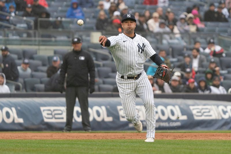 Apr 5, 2023; Bronx, New York, USA; New York Yankees shortstop Isiah Kiner-Falefa (12) throws out Philadelphia Phillies shortstop Edmundo Sosa (33) after fielding a ground ball during the eighth inning at Yankee Stadium. Mandatory Credit: Gregory Fisher-USA TODAY Sports