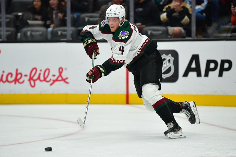 Oct 5, 2023; Anaheim, California, USA; Arizona Coyotes defenseman Juuso Valimaki (4) moves the puck against the Anaheim Ducks during the second period at Honda Center. Mandatory Credit: Gary A. Vasquez-USA TODAY Sports