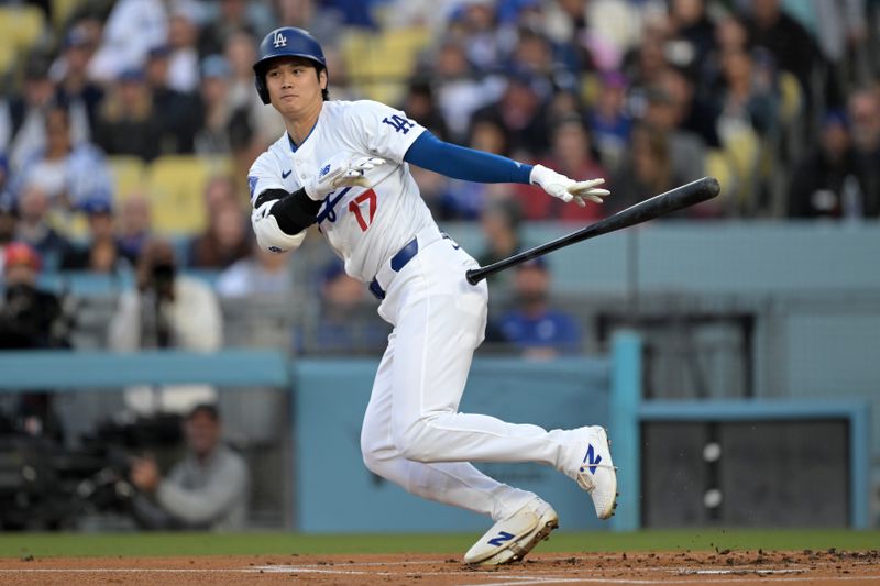 May 20, 2024; Los Angeles, California, USA;  Los Angeles Dodgers designated hitter Shohei Ohtani (17) singles on a bunt in the first inning against the Arizona Diamondbacks at Dodger Stadium. Mandatory Credit: Jayne Kamin-Oncea-USA TODAY Sports