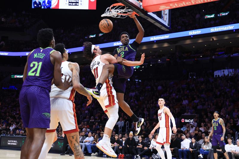 MIAMI, FLORIDA - JANUARY 01: Herbert Jones #2 of the New Orleans Pelicans dunks the ball over Jaime Jaquez Jr. #11 of the Miami Heat during the fourth quarter of the game at Kaseya Center on January 01, 2025 in Miami, Florida. NOTE TO USER: User expressly acknowledges and agrees that, by downloading and or using this photograph, User is consenting to the terms and conditions of the Getty Images License Agreement. (Photo by Megan Briggs/Getty Images)