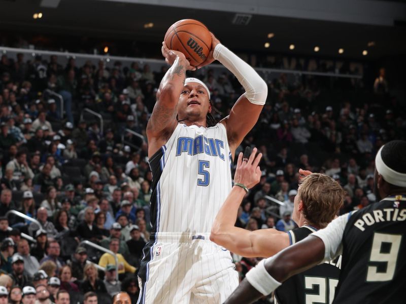 MILWAUKEE, WI - JANUARY 15: Paolo Banchero #5 of the Orlando Magic shoots the ball during the game against the Milwaukee Bucks on January 15, 2025 at Fiserv Forum Center in Milwaukee, Wisconsin. NOTE TO USER: User expressly acknowledges and agrees that, by downloading and or using this Photograph, user is consenting to the terms and conditions of the Getty Images License Agreement. Mandatory Copyright Notice: Copyright 2025 NBAE (Photo by Gary Dineen/NBAE via Getty Images).