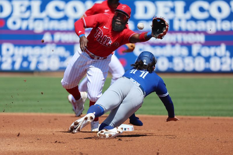 Mar 12, 2023; Clearwater, Florida, USA; Philadelphia Phillies infielder Josh Harrison (2) tags out Toronto Blue Jays shortstop Bo Bichette (11) as he attempts to steal second base during the first inning at BayCare Ballpark. Mandatory Credit: Kim Klement-USA TODAY Sports