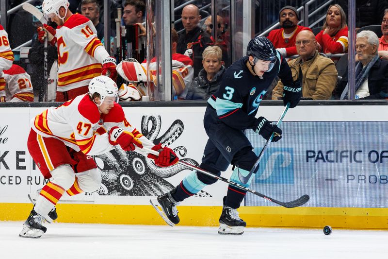 Oct 19, 2024; Seattle, Washington, USA; Seattle Kraken defenseman Will Borgen (3) skates with the puck away from Calgary Flames center Connor Zary (47) during the second period at Climate Pledge Arena. Mandatory Credit: Caean Couto-Imagn Images