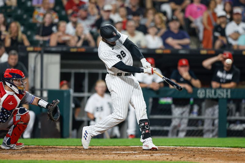 Jul 4, 2023; Chicago, Illinois, USA; Chicago White Sox center fielder Luis Robert Jr. (88) hits a three-run home run against the Toronto Blue Jays during the sixth inning at Guaranteed Rate Field. Mandatory Credit: Kamil Krzaczynski-USA TODAY Sports