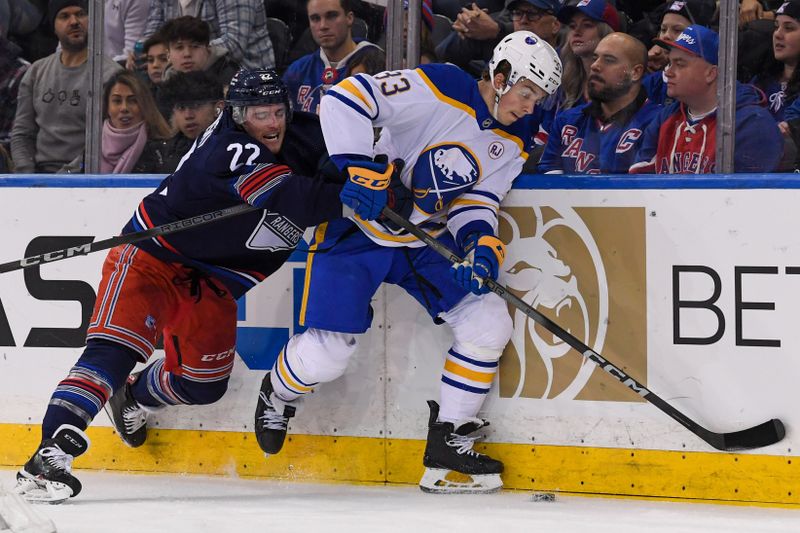 Dec 23, 2023; New York, New York, USA; Buffalo Sabres defenseman Ryan Johnson (33) and New York Rangers center Jonny Brodzinski (22) battle for the puck during the first period at Madison Square Garden. Mandatory Credit: Dennis Schneidler-USA TODAY Sports