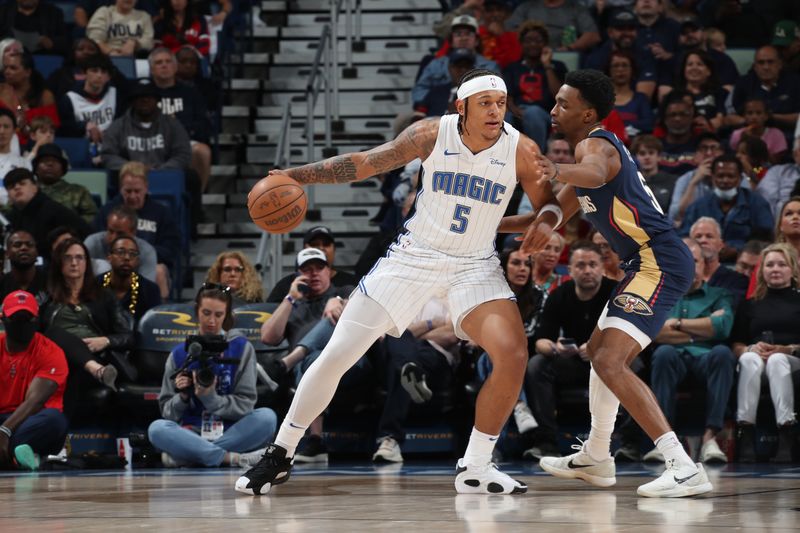 NEW ORLEANS, LA - APRIL 3:  Paolo Banchero #5 of the Orlando Magic handles the ball during the game against the New Orleans Pelicans on April 3, 2024 at the Smoothie King Center in New Orleans, Louisiana. NOTE TO USER: User expressly acknowledges and agrees that, by downloading and or using this Photograph, user is consenting to the terms and conditions of the Getty Images License Agreement. Mandatory Copyright Notice: Copyright 2024 NBAE (Photo by Layne Murdoch Jr./NBAE via Getty Images)