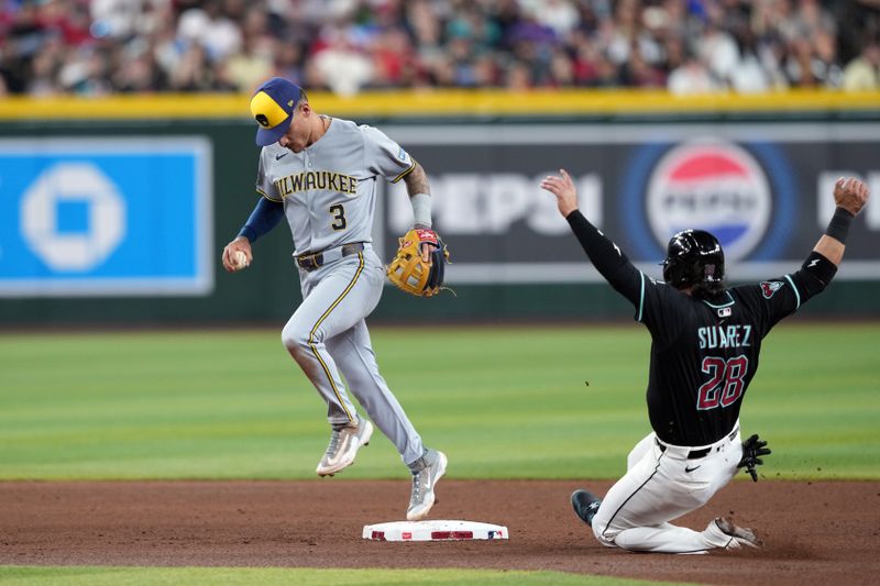 Apr 12, 2025; Phoenix, Arizona, USA; Milwaukee Brewers third base Joey Ortiz (3) steps on second to force out Arizona Diamondbacks third base Eugenio Suárez (28) during the fourth inning at Chase Field. Mandatory Credit: Joe Camporeale-Imagn Images