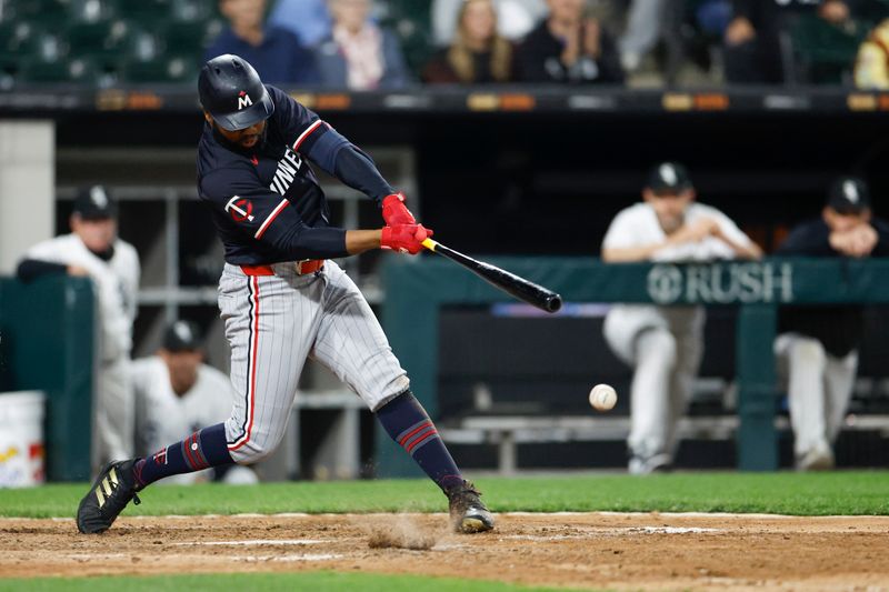 Apr 30, 2024; Chicago, Illinois, USA; Minnesota Twins outfielder Manuel Margot (13) singles against the Chicago White Sox during the ninth inning at Guaranteed Rate Field. Mandatory Credit: Kamil Krzaczynski-USA TODAY Sports