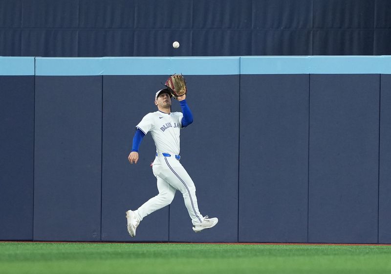May 18, 2025; Toronto, Ontario, CAN; Toronto Blue Jays centre fielder Daulton Varsho (5) catches a fly ball for an out against the Detroit Tigers during the fourth inning at Rogers Centre. Mandatory Credit: Nick Turchiaro-Imagn Images