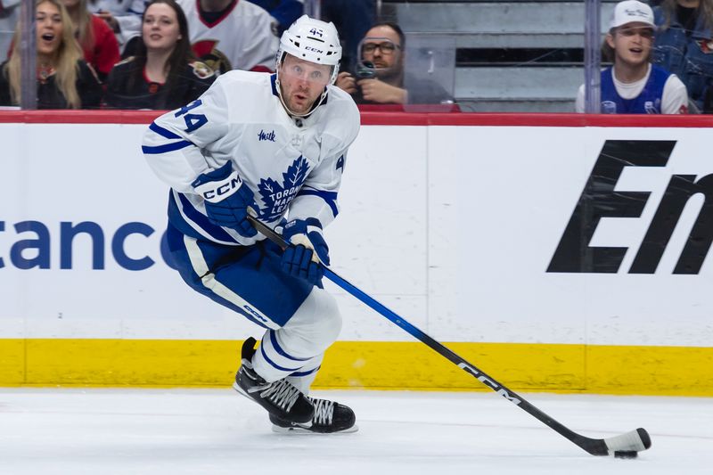 Apr 26, 2025; Ottawa, Ontario, CAN; Toronto Maple Leafs defenseman Morgan Rielly (44) skates with the puck in game four of the first round of the 2025 Stanley Cup Playoffs against the Ottawa Senators at the Canadian Tire Centre. Mandatory Credit: Marc DesRosiers-Imagn Images