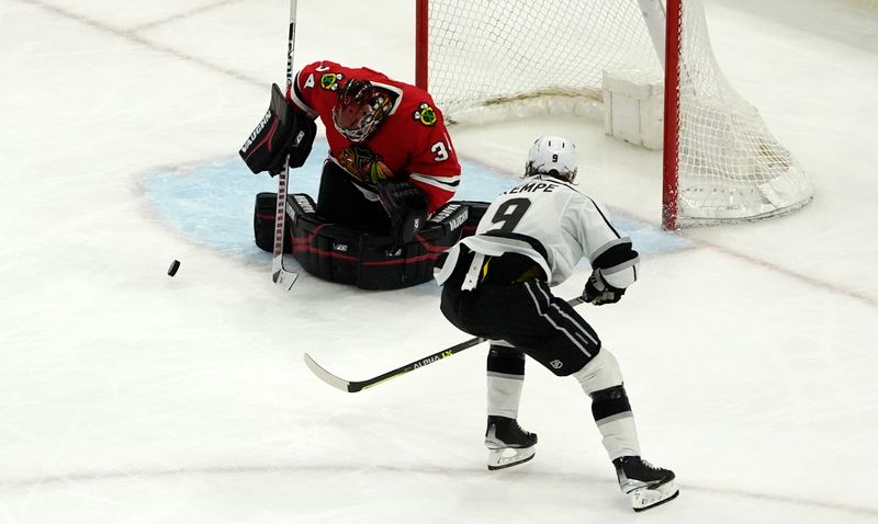 Jan 22, 2023; Chicago, Illinois, USA; Los Angeles Kings right wing Adrian Kempe (9) shoots on Chicago Blackhawks goaltender Petr Mrazek (34) during the third period at United Center. Mandatory Credit: David Banks-USA TODAY Sports