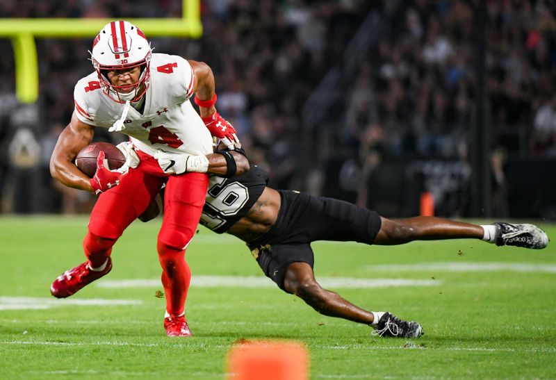 Sep 22, 2023; West Lafayette, Indiana, USA; Purdue Boilermakers cornerback Marquis Wilson (16) tackles Wisconsin Badgers wide receiver C.J. Williams (4) during the first half at Ross-Ade Stadium. Mandatory Credit: Robert Goddin-USA TODAY Sports