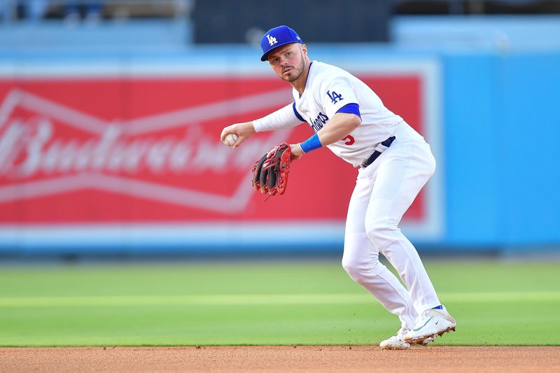 May 4, 2024; Los Angeles, California, USA; Los Angeles Dodgers second baseman Gavin Lux (9) throws to first for the out against Atlanta Braves right fielder Ronald Acuña Jr. (13) during the first inning at Dodger Stadium. Mandatory Credit: Gary A. Vasquez-USA TODAY Sports