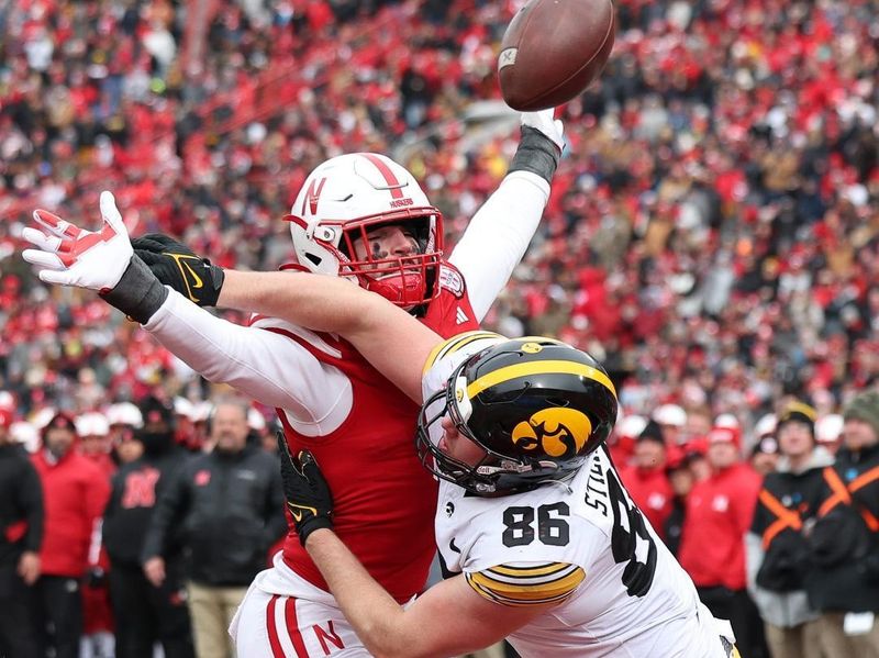 Nov 24, 2023; Lincoln, Nebraska, USA; Nebraska Cornhuskers linebacker John Bullock (5) defends the pass on Iowa Hawkeyes tight end Steven Stilianos (86) at Memorial Stadium. Mandatory Credit: Reese Strickland-USA TODAY Sports