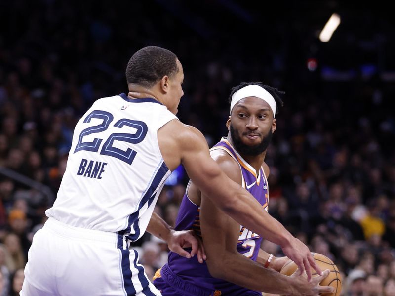 PHOENIX, ARIZONA - JANUARY 07: Josh Okogie #2 of the Phoenix Suns drives against Desmond Bane #22 of the Memphis Grizzlies during the first half at Footprint Center on January 07, 2024 in Phoenix, Arizona. NOTE TO USER: User expressly acknowledges and agrees that, by downloading and or using this photograph, User is consenting to the terms and conditions of the Getty Images License Agreement.  (Photo by Chris Coduto/Getty Images)