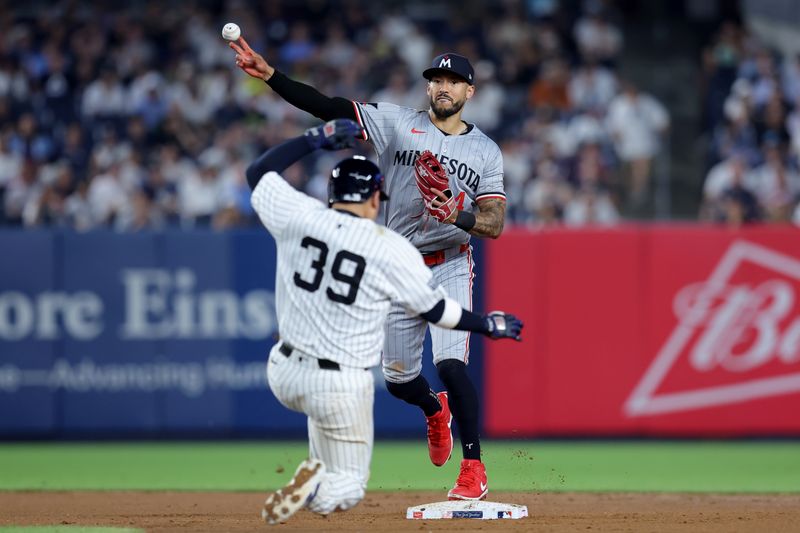 Jun 4, 2024; Bronx, New York, USA; Minnesota Twins shortstop Carlos Correa (4) forces out New York Yankees catcher Jose Trevino (39) at second base and throws to first to complete a double play on a ball hit by Yankees third baseman DJ LeMahieu (not pictured) during the seventh inning at Yankee Stadium. Mandatory Credit: Brad Penner-USA TODAY Sports