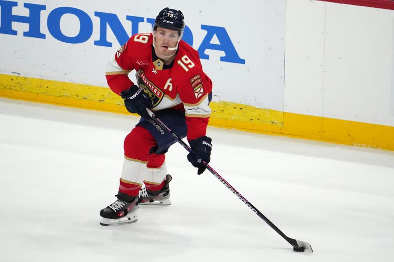 Dec 29, 2023; Sunrise, Florida, USA; Florida Panthers left wing Matthew Tkachuk (19) plays the puck against the New York Rangers during the first period at Amerant Bank Arena. Mandatory Credit: Jasen Vinlove-USA TODAY Sports