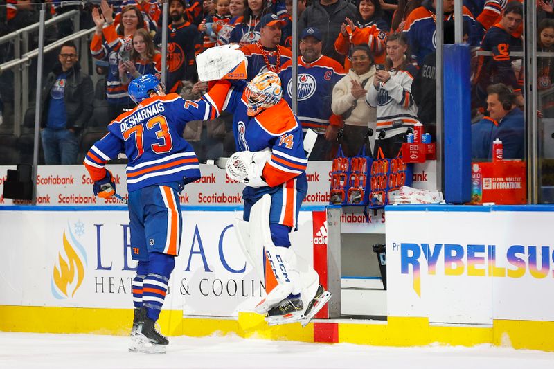 Jan 27, 2024; Edmonton, Alberta, CAN; Edmonton Oilers defensemen Vincent Desharnais (73) and goaltender Stuart Skinner (74) celebrate the Oilers 4-1 victory over the Nashville Predators. It is the Oilers 16th straight win at Rogers Place. Mandatory Credit: Perry Nelson-USA TODAY Sports