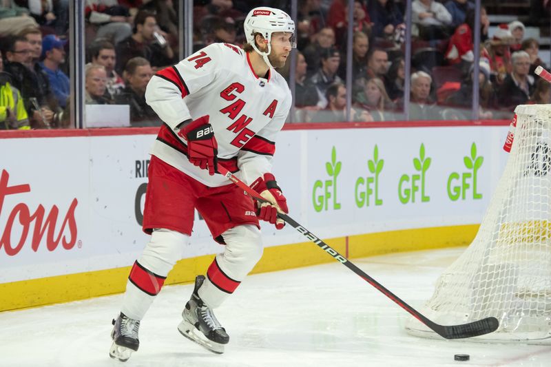 Dec 12, 2023; Ottawa, Ontario, CAN; Carolina Hurricanes defenseman Jaccob Slavin (74) skates with the puck in the first period against the Ottawa Senators at the Canadian Tire Centre. Mandatory Credit: Marc DesRosiers-USA TODAY Sports