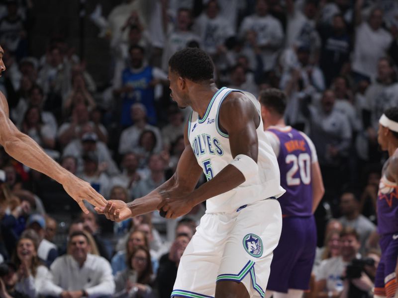 MINNEAPOLIS, MN -  APRIL 23: Anthony Edwards #5 of the Minnesota Timberwolves celebrates a three point basket during the game against the Phoenix Suns during Round One Game Two of the 2024 NBA Playoffs on April 23, 2024 at Target Center in Minneapolis, Minnesota. NOTE TO USER: User expressly acknowledges and agrees that, by downloading and or using this Photograph, user is consenting to the terms and conditions of the Getty Images License Agreement. Mandatory Copyright Notice: Copyright 2024 NBAE (Photo by Jordan Johnson/NBAE via Getty Images)