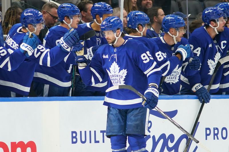 Oct 24, 2024; Toronto, Ontario, CAN; Toronto Maple Leafs defenseman Oliver Ekman-Larsson (95) gets congratulated after his goal against the St. Louis Blues during the second period at Scotiabank Arena. Mandatory Credit: John E. Sokolowski-Imagn Images