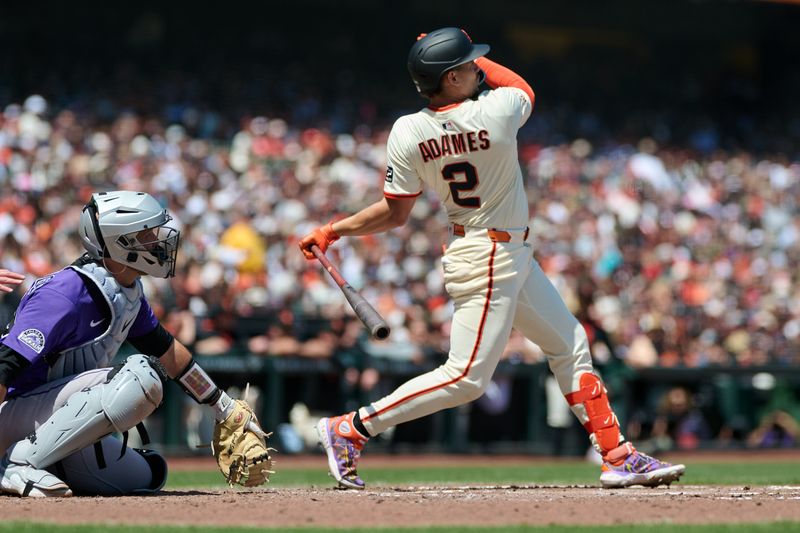 May 4, 2025; San Francisco, California, USA; San Francisco Giants shortstop Willy Adames (2) hits an RBI double against the Colorado Rockies during the fifth inning at Oracle Park. Mandatory Credit: Robert Edwards-Imagn Images