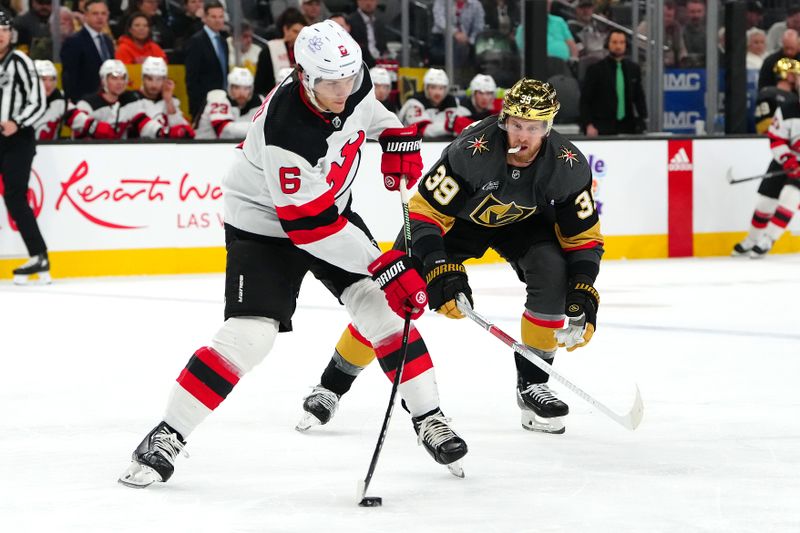 Mar 17, 2024; Las Vegas, Nevada, USA; New Jersey Devils defenseman John Marino (6) clears the puck away from Vegas Golden Knights right wing Anthony Mantha (39) during the first period at T-Mobile Arena. Mandatory Credit: Stephen R. Sylvanie-USA TODAY Sports