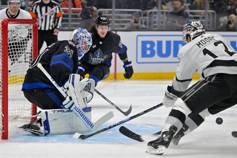 Jan 2, 2024; Los Angeles, California, USA; Toronto Maple Leafs goaltender Martin Jones (31) defends a shot on goal by Los Angeles Kings left wing Trevor Moore (12) in the second period at Crypto.com Arena. Mandatory Credit: Jayne Kamin-Oncea-USA TODAY Sports